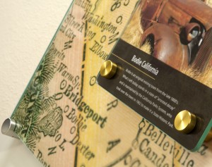 Decorative glass panel mounted with brass standoffs.