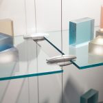 Glass floating shelves suspended using Gyford panel grippers and wire systems