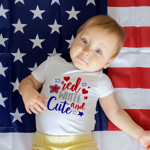 baby laying on American flag with a white vapor one piece that says red white and cute