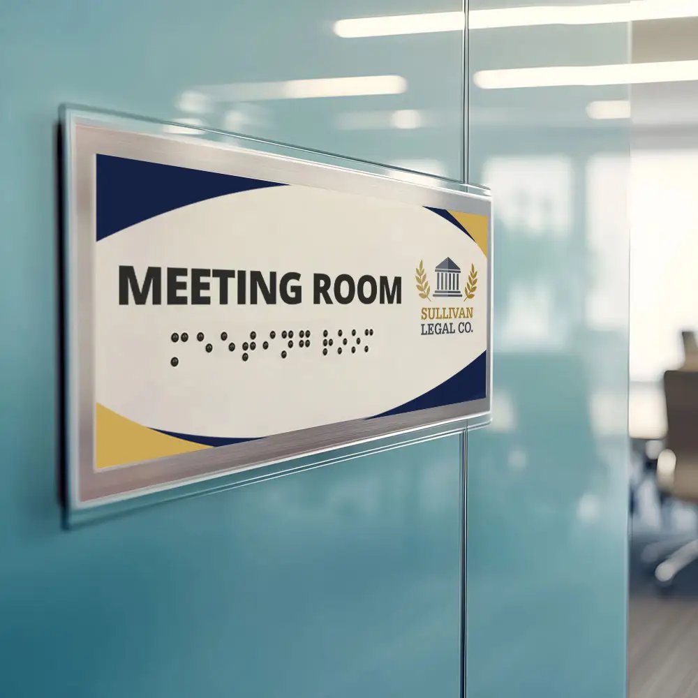 image of a sign hanging in an office that has a UV printed design and legal co logo and ADA applique and braille that says Meeting Room