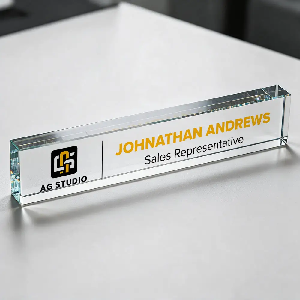 clear acrylic block with a logo printed on it in orange, white and black with the name Johnathan Andrews and his title Sales Representative