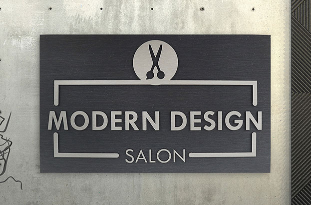 Rowmark LaserMax layered Modern Design Salon sign hanging on a wall