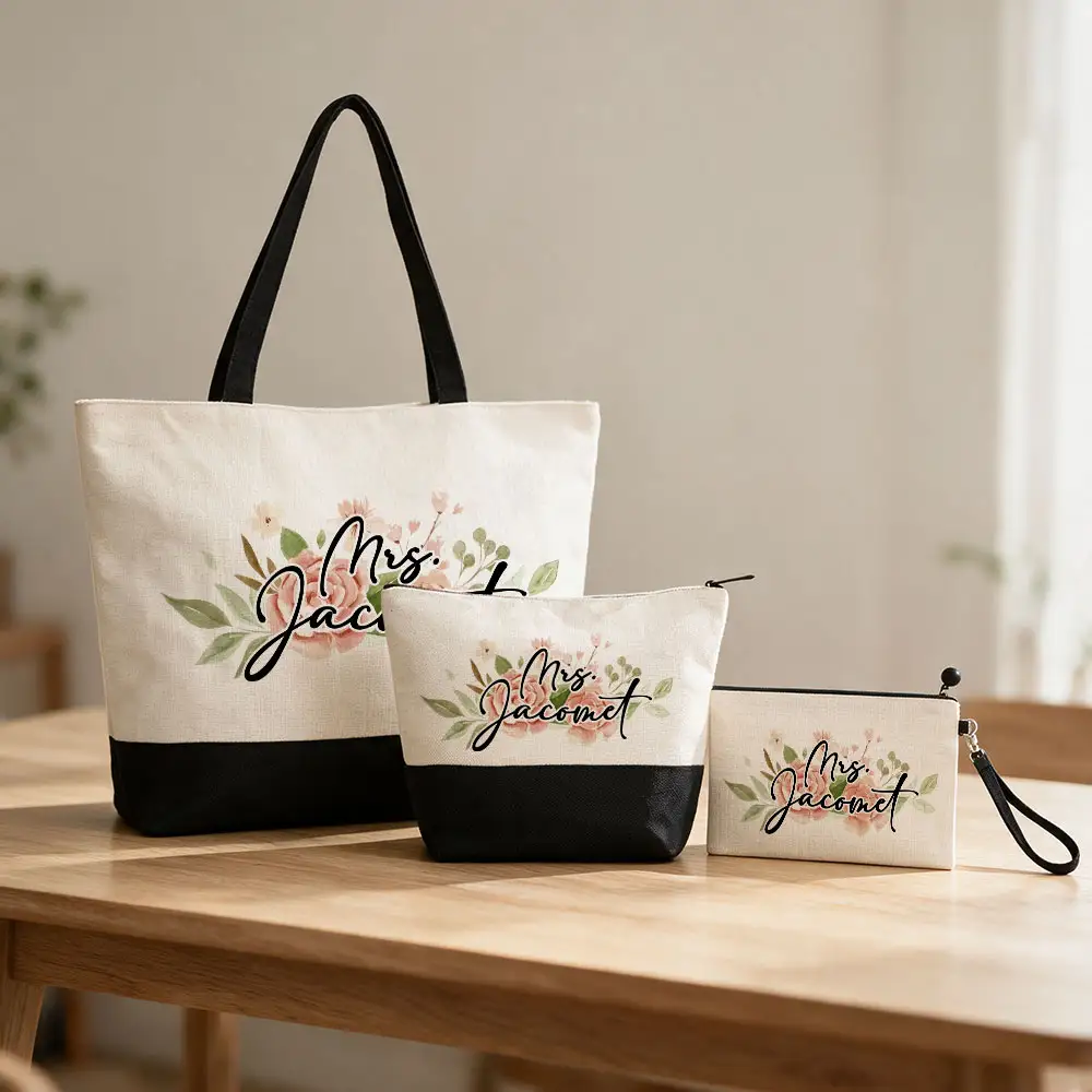 Personalized cream and black tote bag, cosmetic bag, and wristlet featuring floral designs and custom script lettering.