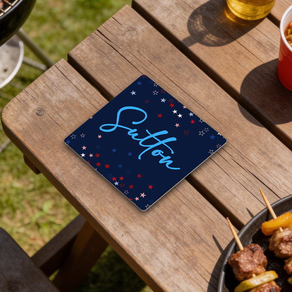 Monarch Sandstone coaster with Patriotic star background printed on it with the last name "Sutton" on a picnic table