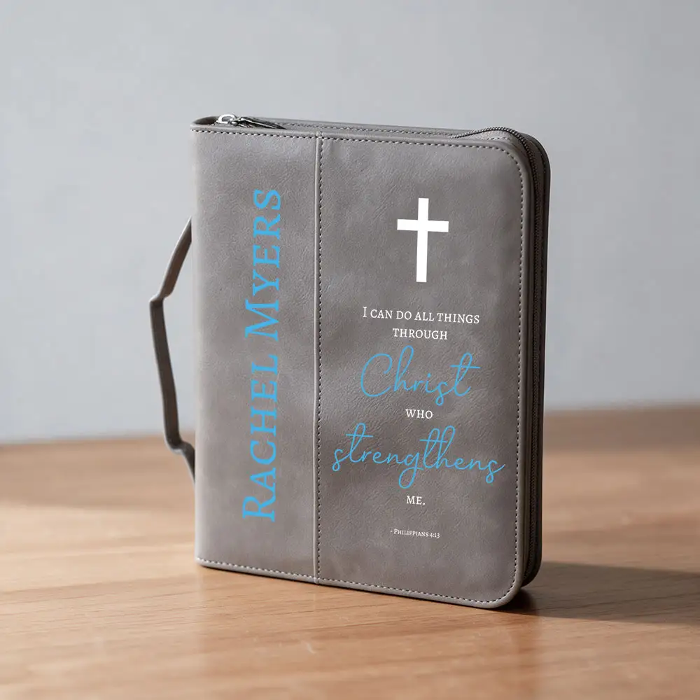 Iron Gray Saddle Bible Cover sitting on a desk with printed name