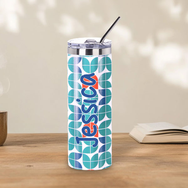 white skinny tumbler UV printed the name Jessica in blue with a blue, teal and red pattern