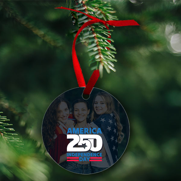 round christmas ornament with photo of friends and America 250 logo printed on it hanging on Christmas tree