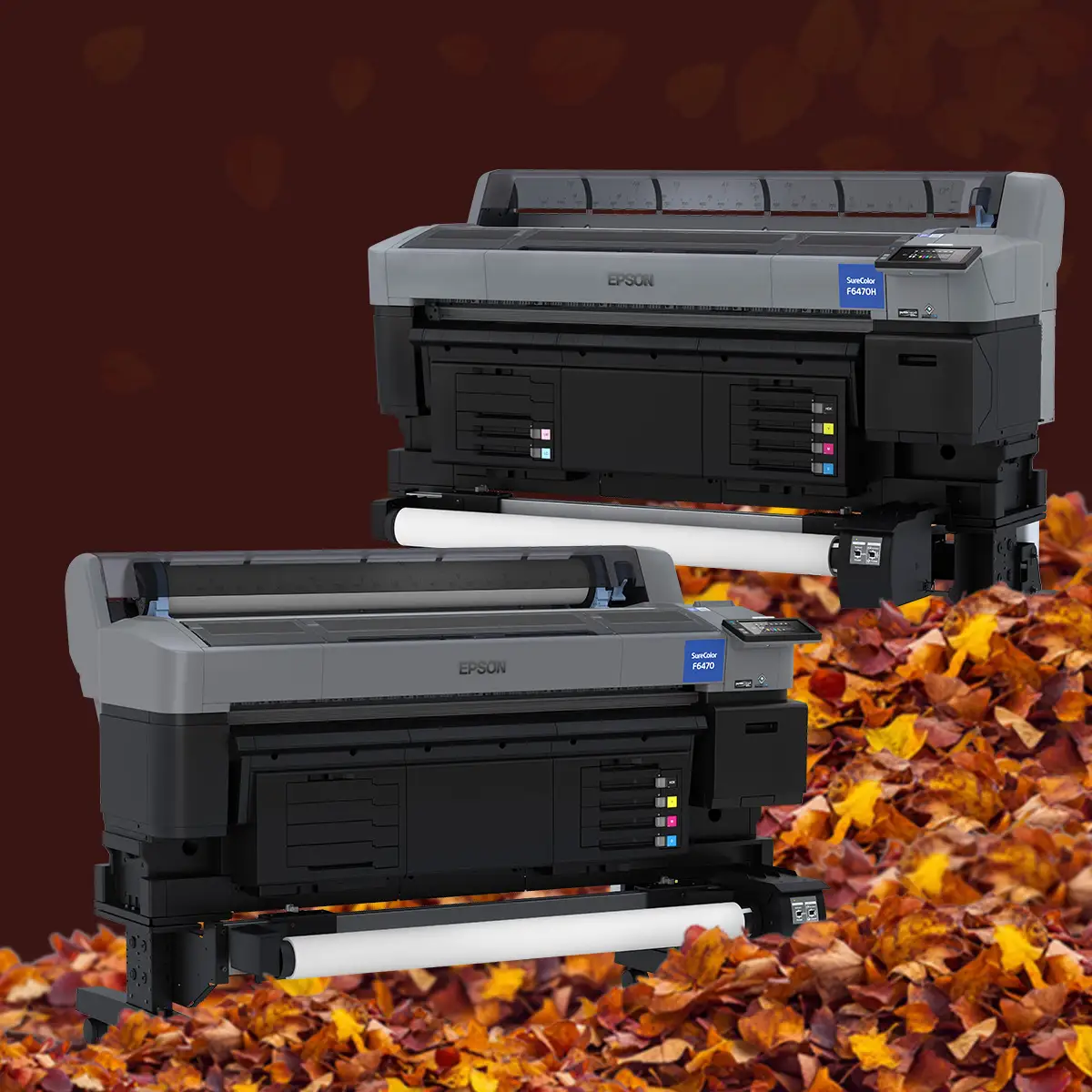Two Epson SureColor wide-format printers against a dark brown background with scattered autumn leaves and a pile of fall leaves along the bottom.